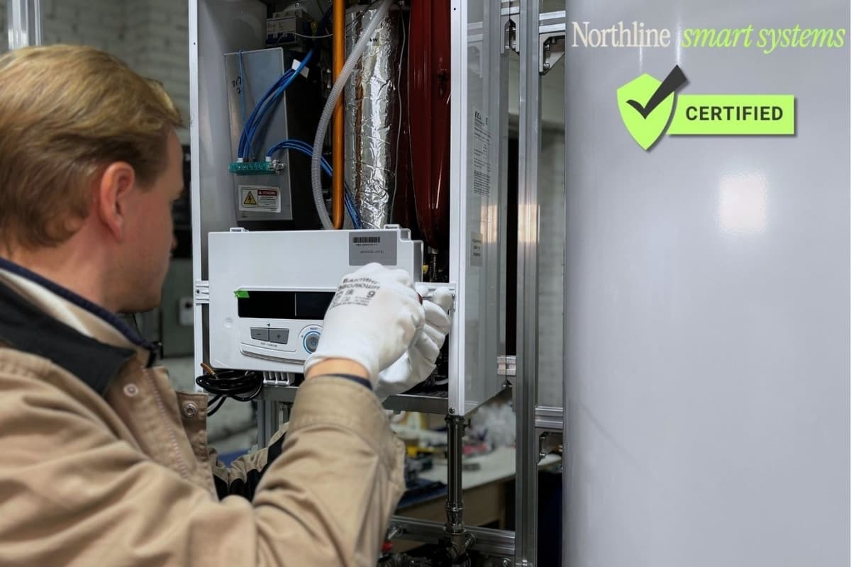 A gloved technician configuring a wall-mounted smart control and climate panel